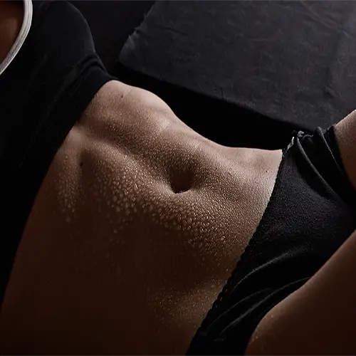 xclose up of a woman's abs while workiong out