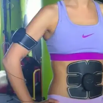 Girl wearing EMS on stomach and arm